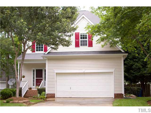 828 Cedar Downs Drive Raleigh, NC 27607 - Photo 1 of 16 a front view of a house with a yard and garage