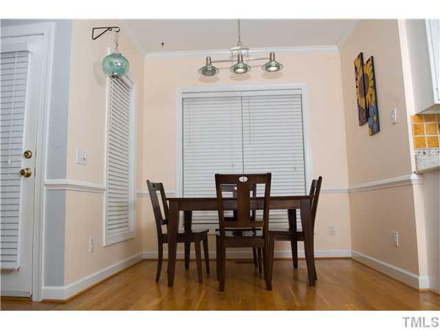 828 Cedar Downs Drive Raleigh, NC 27607 - Photo 5 of 16 a view of a dining room with furniture and chandelier