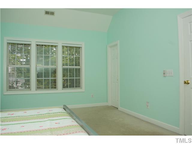 828 Cedar Downs Drive Raleigh, NC 27607 - Photo 8 of 16 a view of an empty room with a window