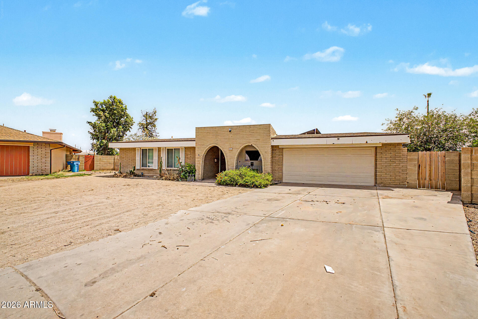4007 West Mountain View Road Phoenix, AZ 85051 - Photo 2 of 31 a big white house with a yard and car parked