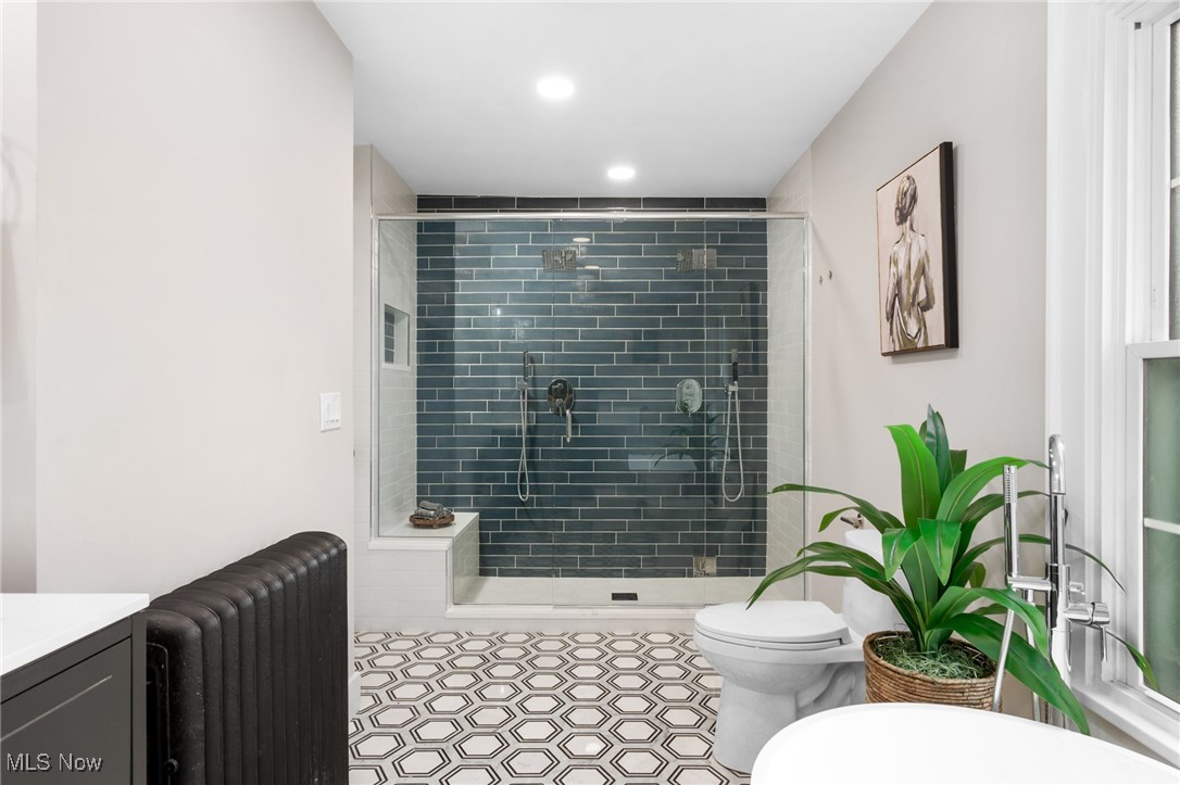 2854 Corydon Road Cleveland, OH 44118 - Photo 24 of 41 Full bathroom with a stall shower, toilet, vanity, radiator heating unit, and recessed lighting