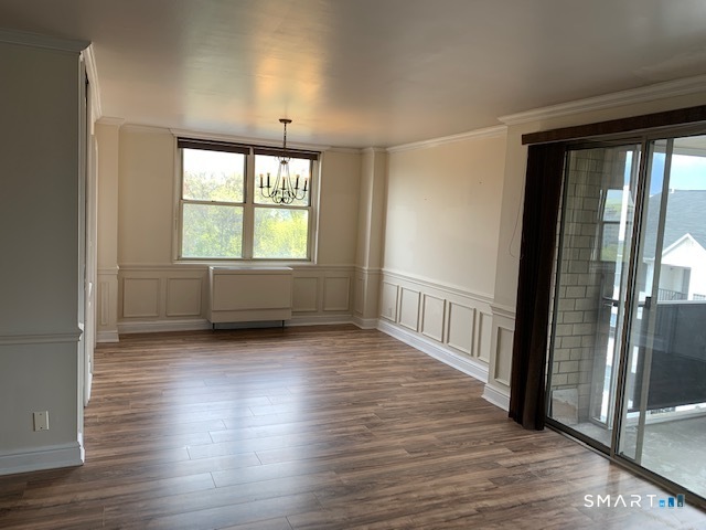 50 Glenbrook Road, Unit 5G Stamford, CT 06902 - Photo 37 of 40 an empty room with wooden floor and windows
