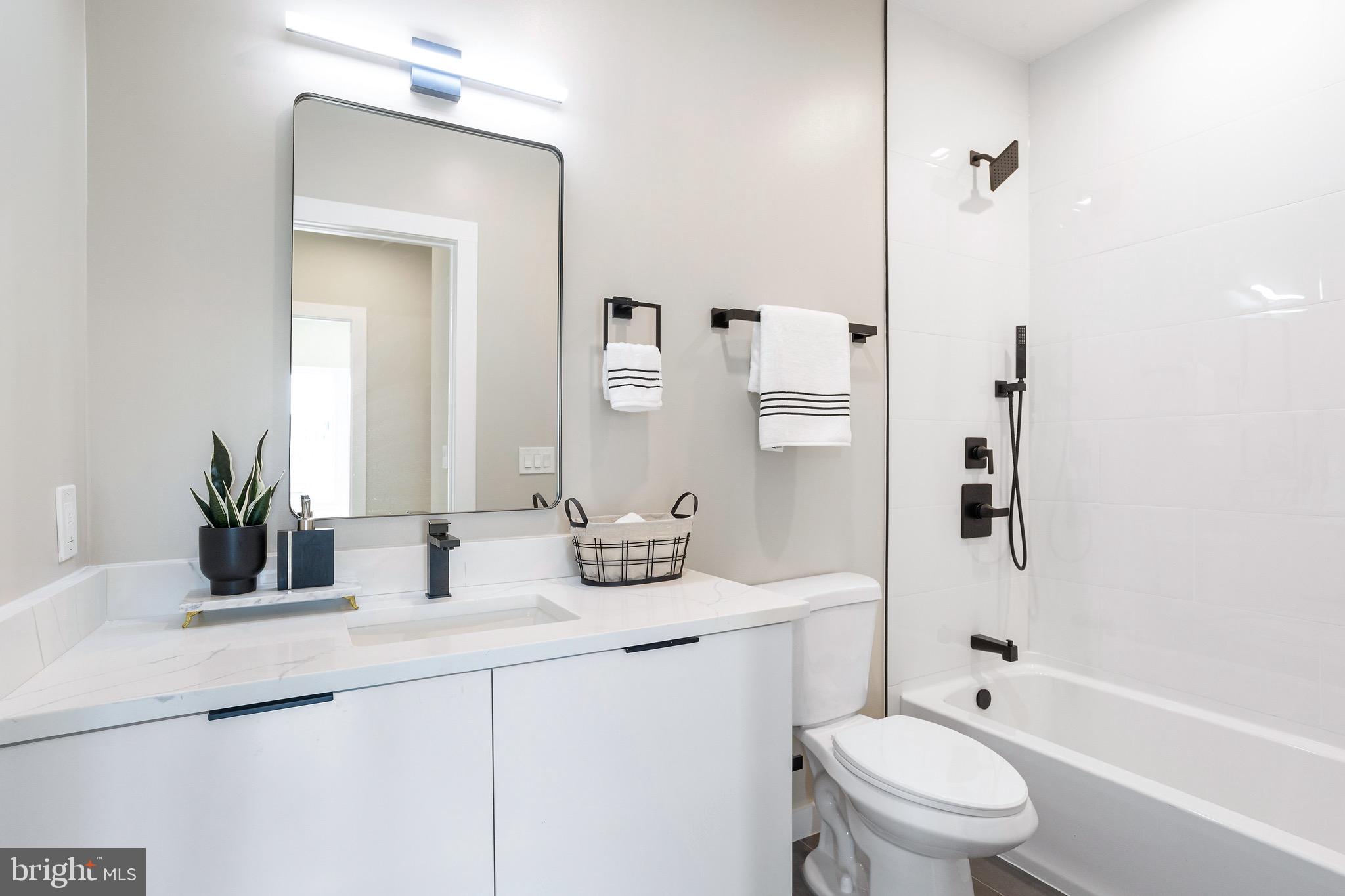 1358 Florida Avenue Northeast, Unit 402 Washington, DC 20002 - Photo 14 of 19 a bathroom with a sink a toilet and shower