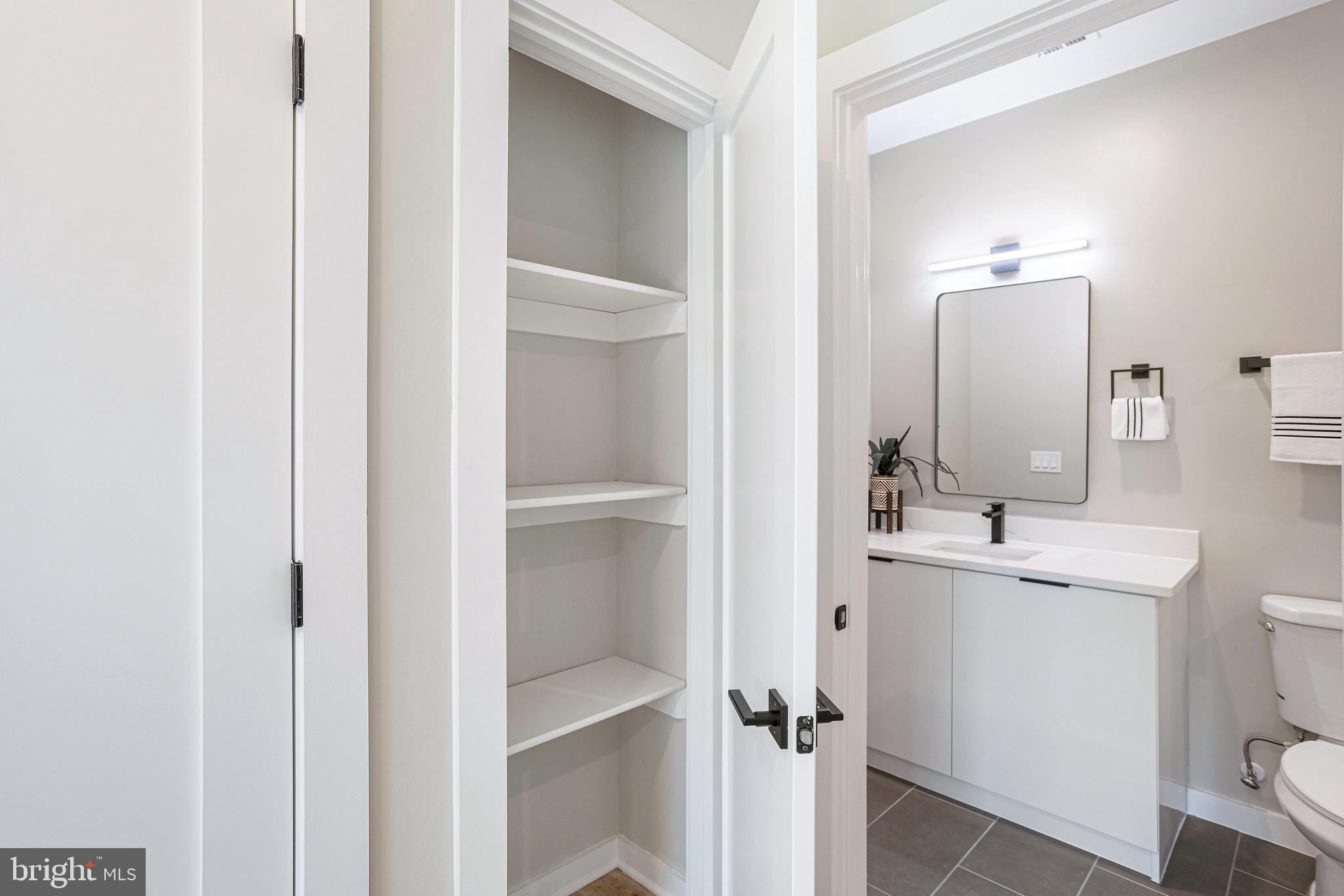 1358 Florida Avenue Northeast, Unit 402 Washington, DC 20002 - Photo 7 of 19 a bathroom with a sink toilet and mirror