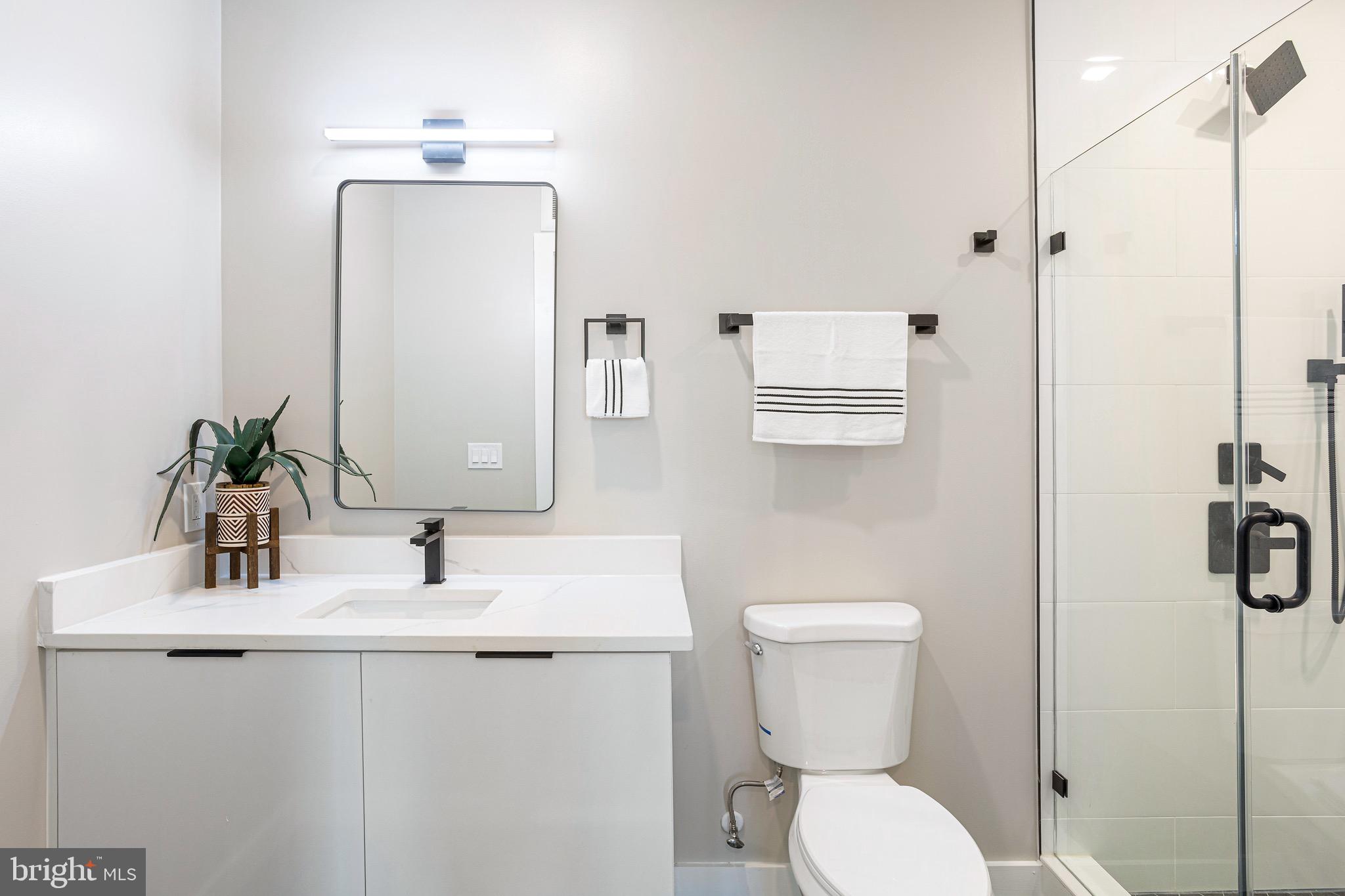 1358 Florida Avenue Northeast, Unit 402 Washington, DC 20002 - Photo 9 of 19 a bathroom with a toilet sink and mirror