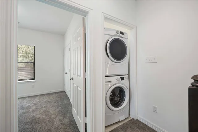 a view of a hallway with washer and dryer