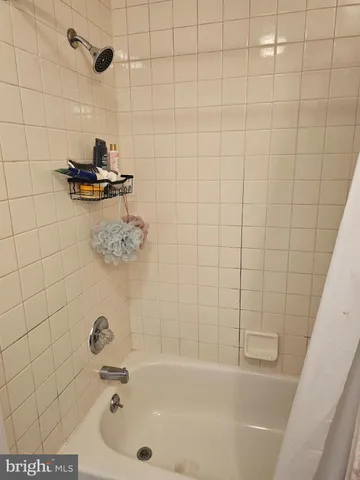 a bathroom with a granite countertop toilet sink and mirror