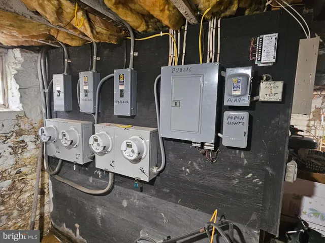 a backyard of a house with large trees and a wooden fence