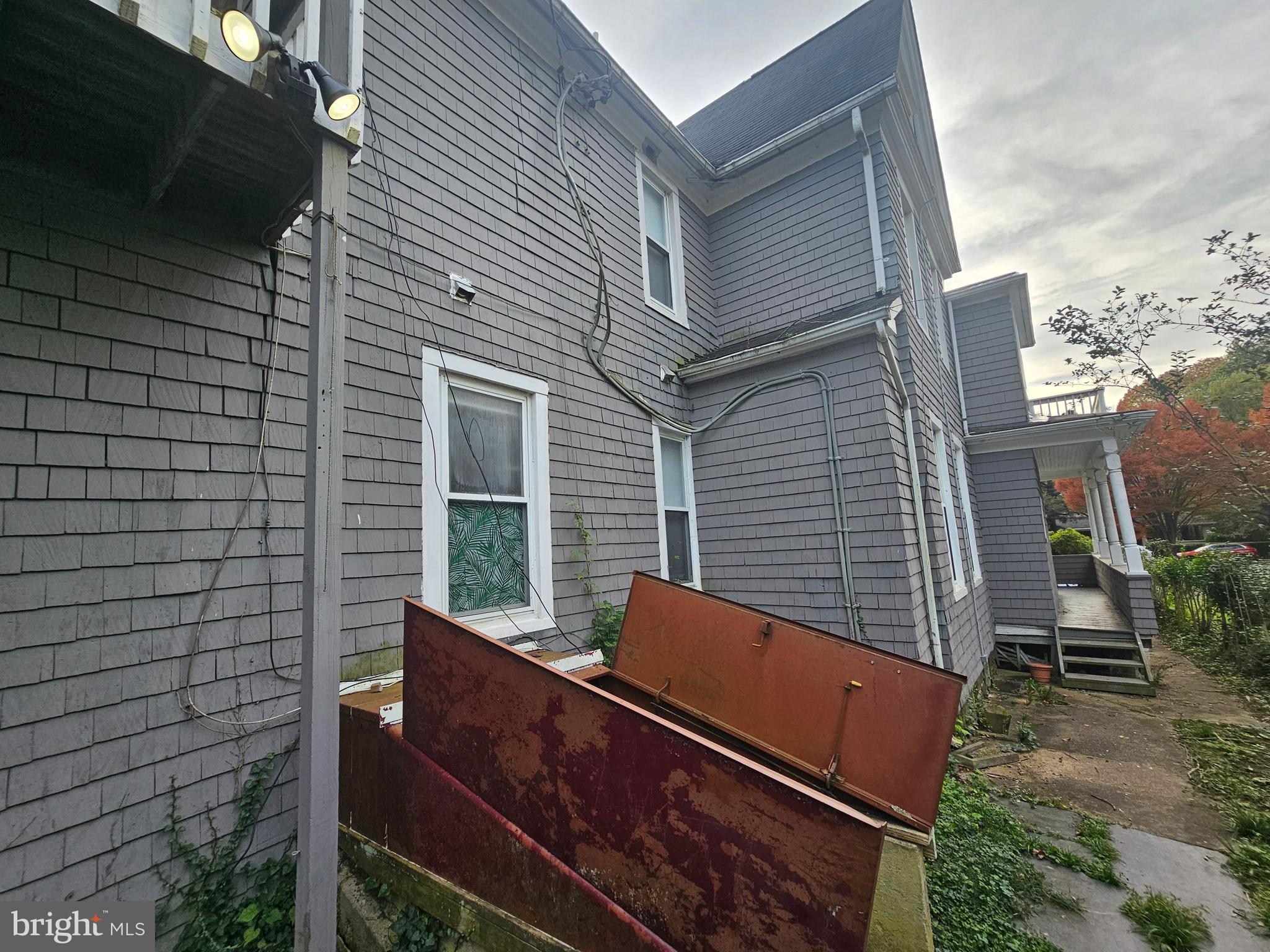5017 Roland Avenue Baltimore, MD 21210 - Photo 28 of 35 a backyard of a house with large trees and a wooden fence