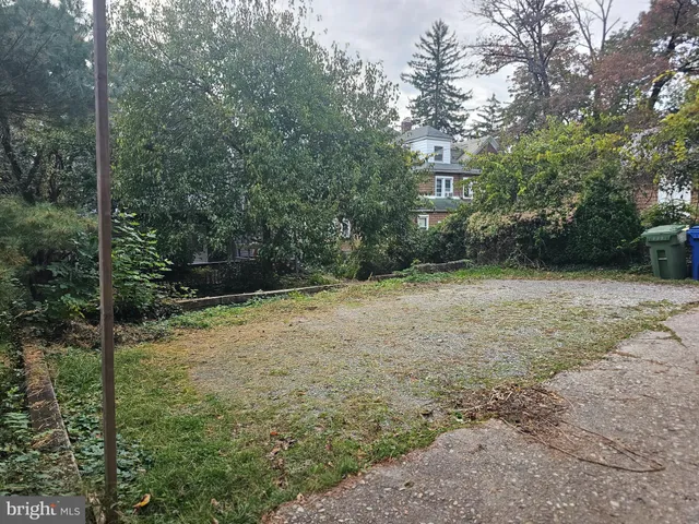 a backyard of a house with lots of green space and fountain