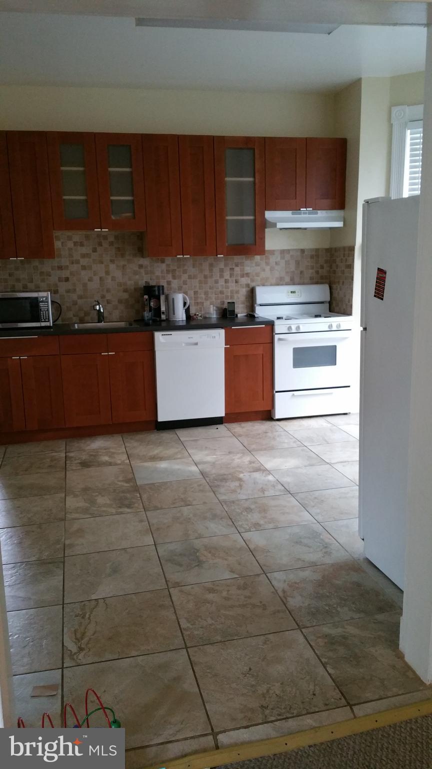 5017 Roland Avenue Baltimore, MD 21210 - Photo 6 of 35 a kitchen with stainless steel appliances granite countertop a stove a sink and a refrigerator