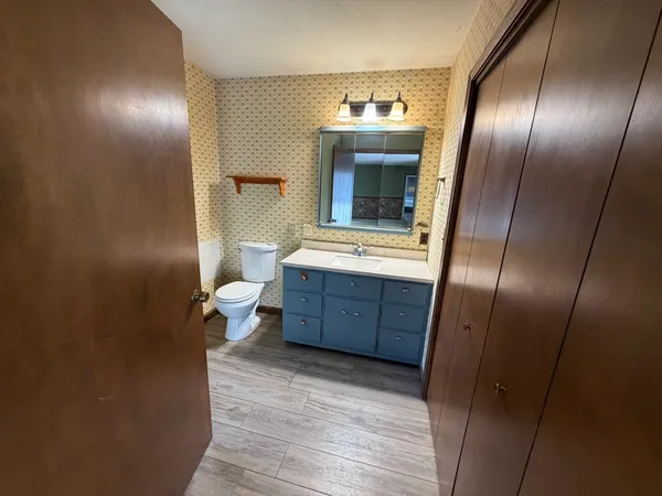 a room with a refrigerator and a mirror