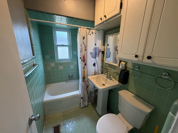 a bathroom with a sink mirror toilet and bathtub