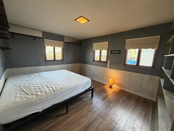 a bedroom with a bed and window