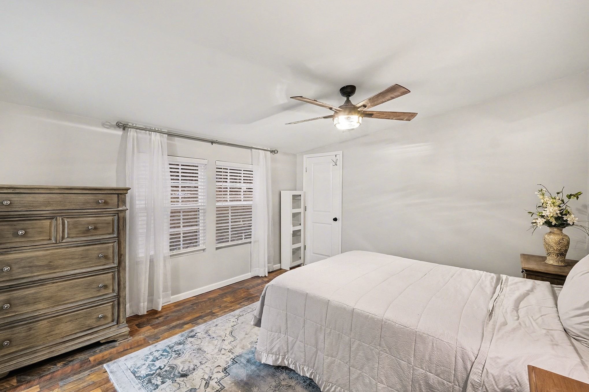 44 Opossum Hollow Road Gordonsville, TN 38563 - Photo 11 of 28 a bedroom with a large bed and a chandelier