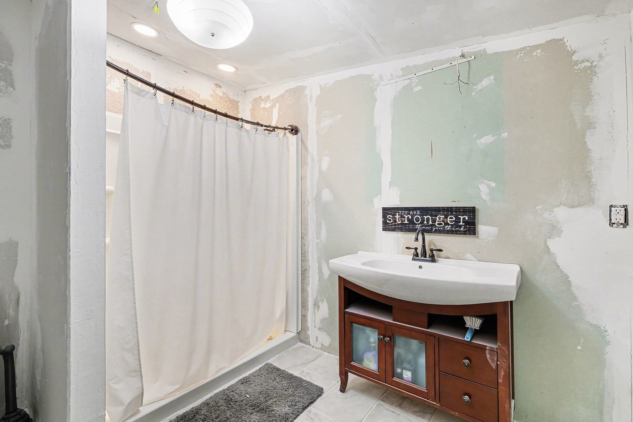 44 Opossum Hollow Road Gordonsville, TN 38563 - Photo 12 of 28 a bathroom with a sink a mirror and a shower