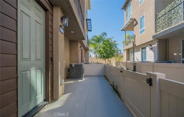 a front view of a house with a yard and potted plants