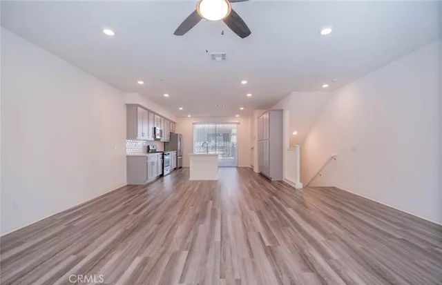 a kitchen with stainless steel appliances granite countertop a stove refrigerator sink and microwave