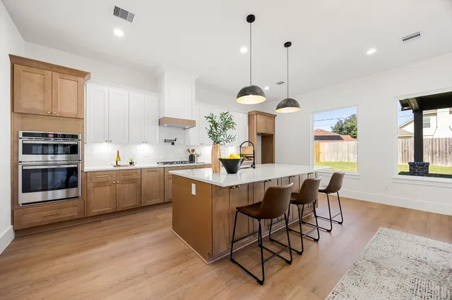 a kitchen with a sink a counter space and appliances