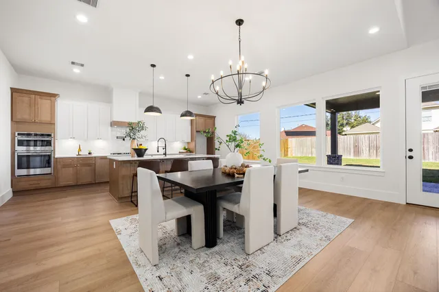 a kitchen with a stove and wooden cabinets