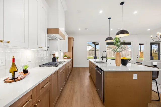 a view of a dining room with furniture a chandelier and wooden floor