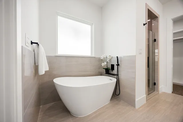 a bathroom with a bathtub and shower