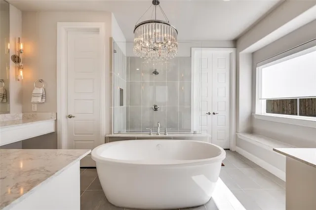 a spacious bathroom with a granite countertop tub sink and mirror