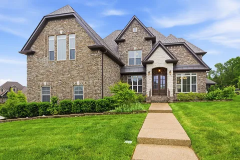 a front view of a house with a yard
