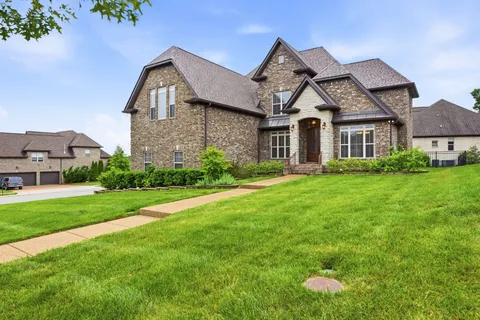 a front view of a house with garden