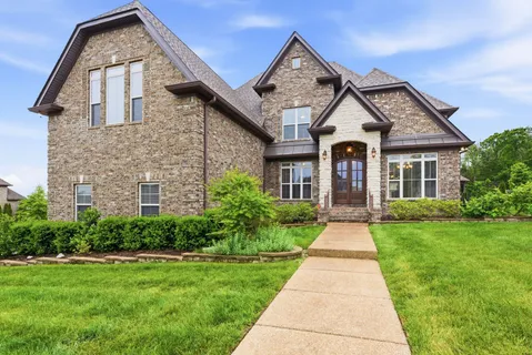 a front view of a house with yard