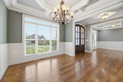 a view of a dining room with furniture wooden floor and chandelier