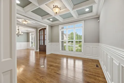 a kitchen with stainless steel appliances granite countertop a sink a stove and a wooden floors