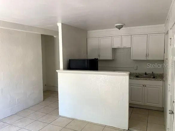 a kitchen with a cabinets and white appliances
