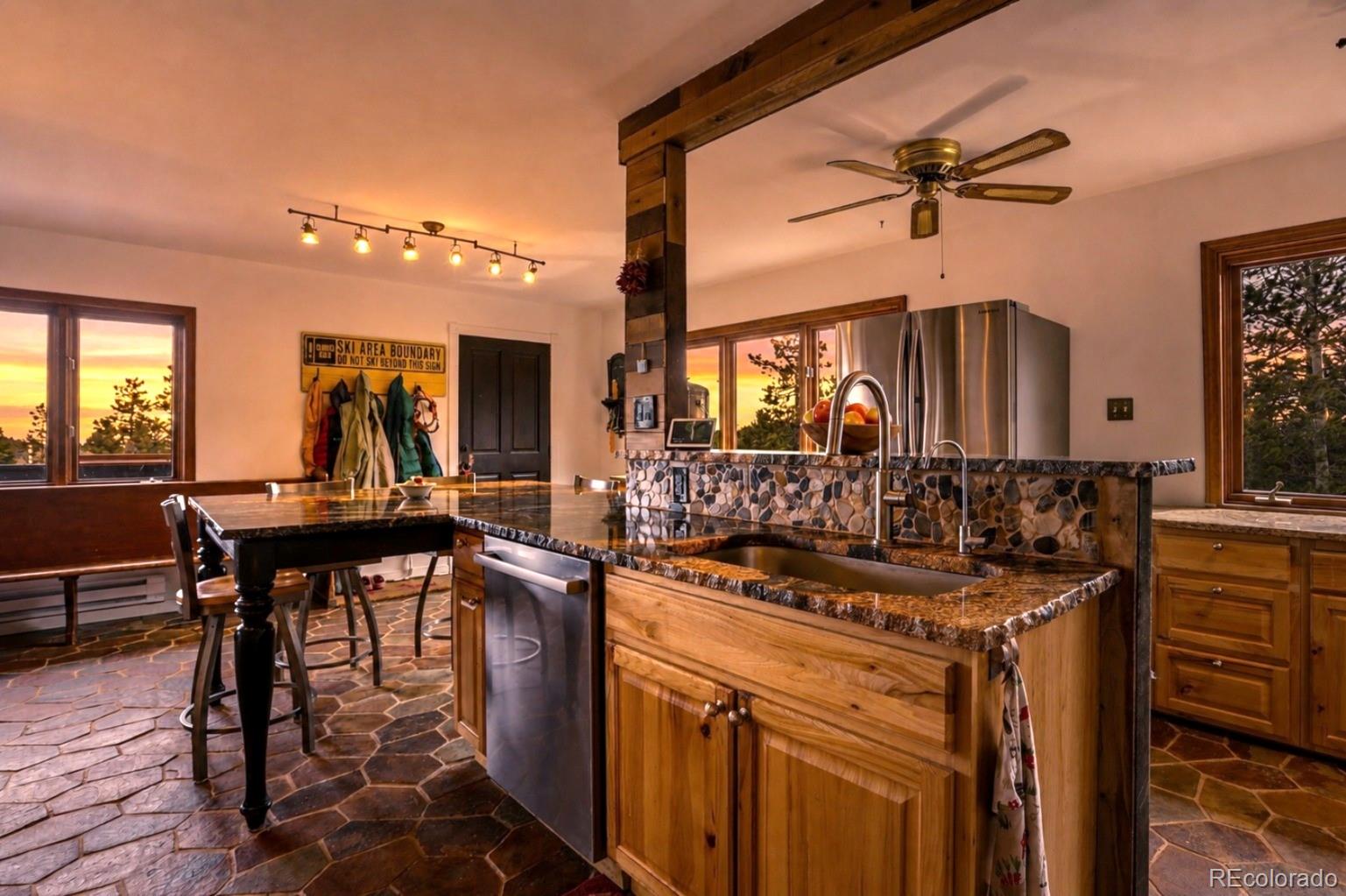 9225 Sandy Lane Conifer, CO 80433 - Photo 11 of 45 a view of a a dining table chairs and chandelier