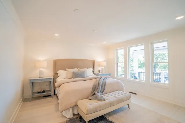 a bedroom with a large bed and a large window