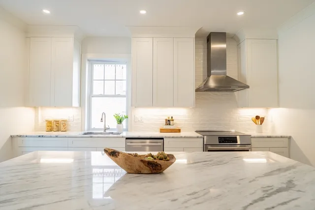 a kitchen with granite countertop a stove and a sink