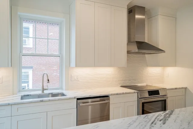 a kitchen that has a sink and a stove in it
