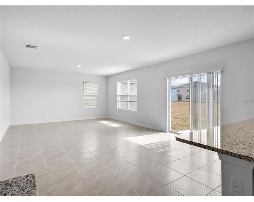 3993 Rory Oak Circle Apopka, FL 32703 - Photo 4 of 19 a view of empty room with windows