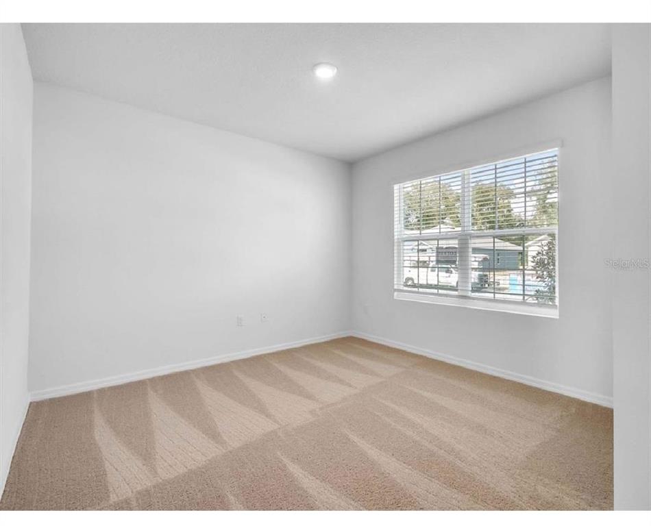3993 Rory Oak Circle Apopka, FL 32703 - Photo 7 of 19 a view of an empty room with a window