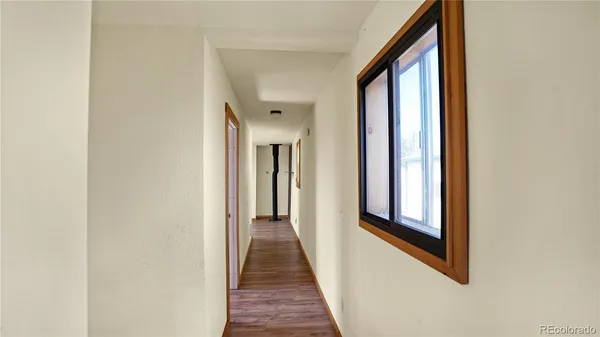 a view of a room with wooden floor and windows