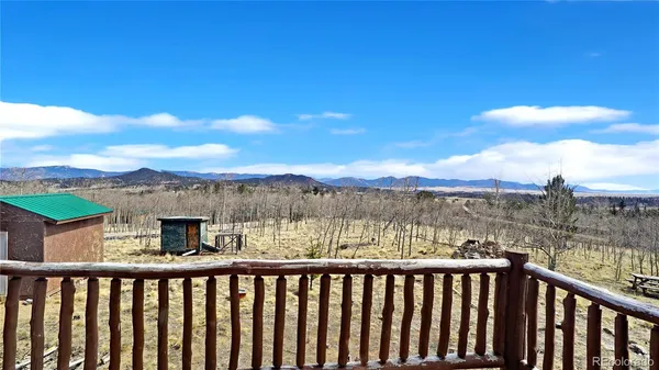 a view of outdoor space with wooden floor and iron stairs
