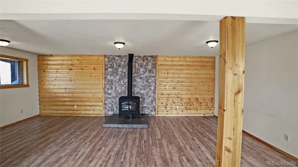 a view of empty room with a fireplace and wooden floor