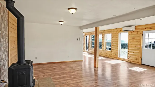 a view of an entryway with wooden floor