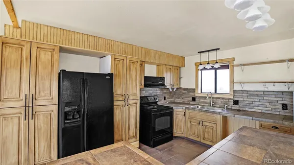 a kitchen with a sink stove and refrigerator