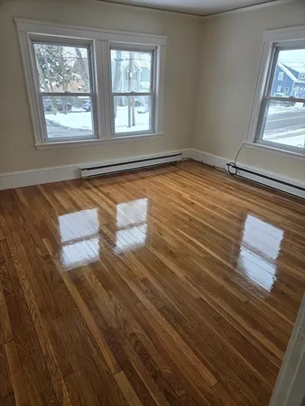 a view of wooden floor and windows in a room
