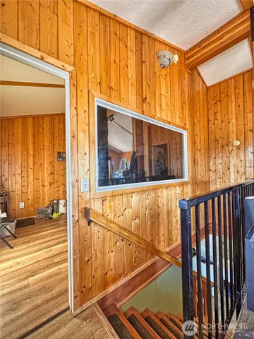 a view of a room with wooden floor and windows