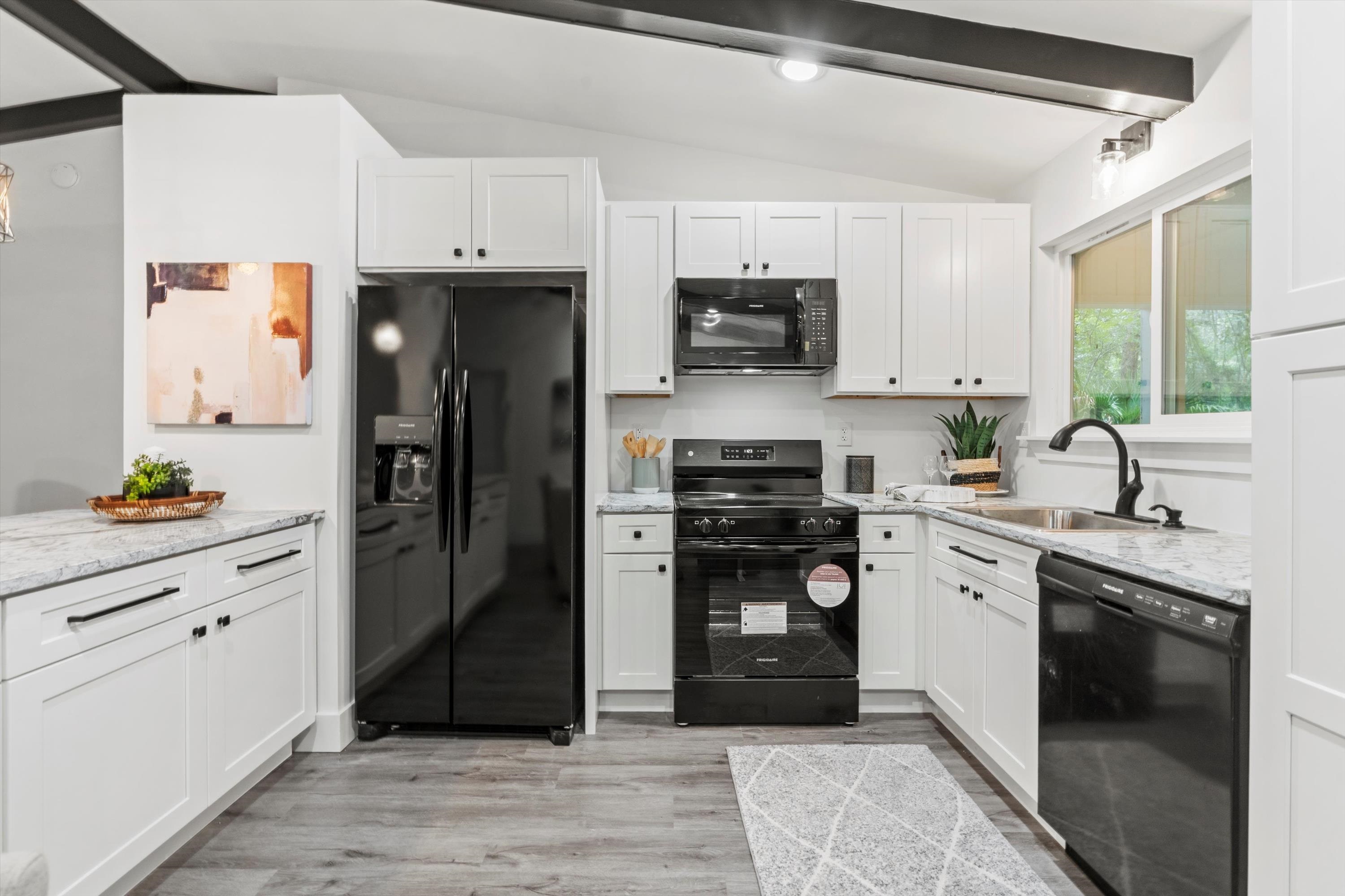 2884 Kings Road St. Augustine, FL 32086 - Photo 11 of 27 a kitchen with stainless steel appliances a refrigerator sink and microwave