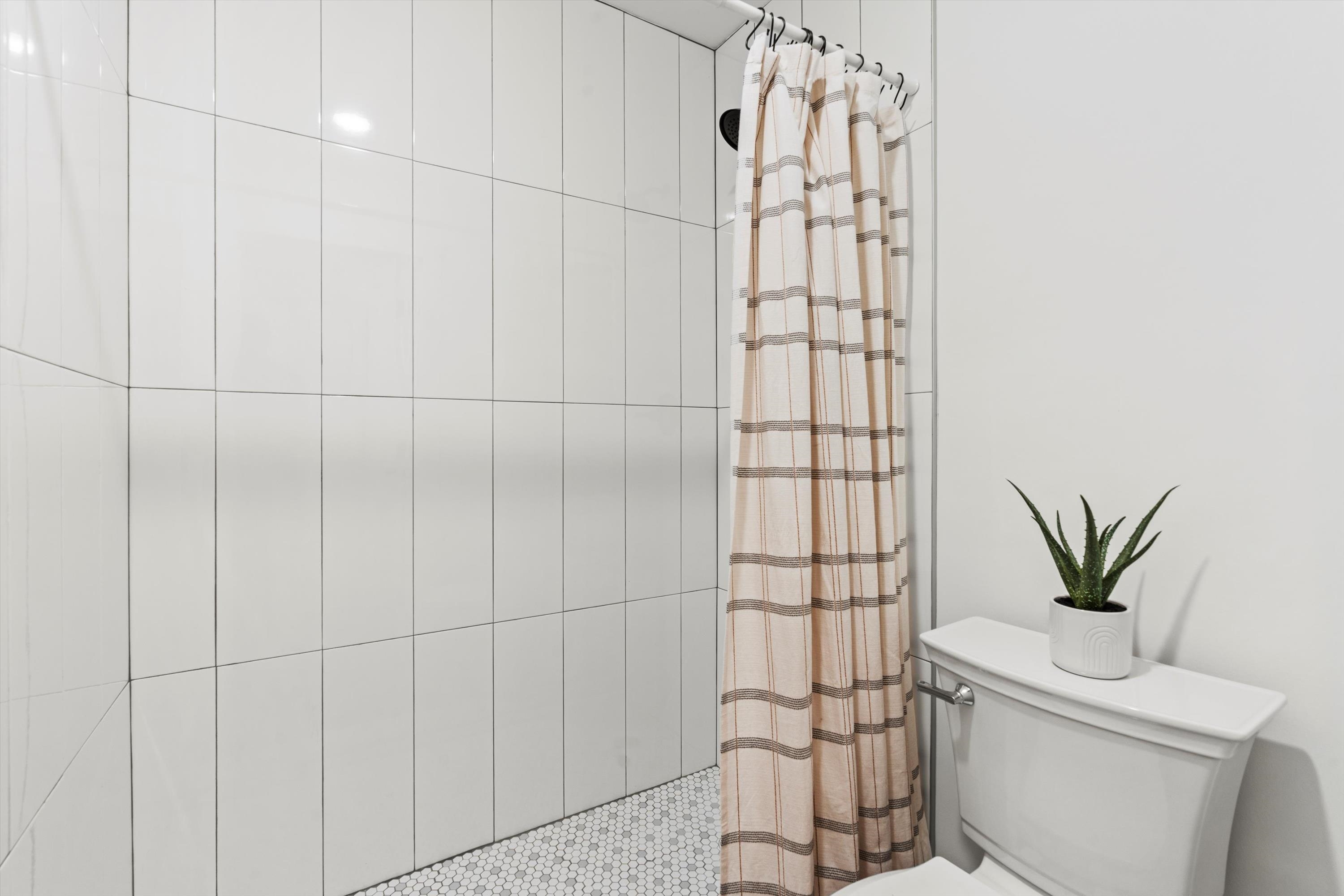 2884 Kings Road St. Augustine, FL 32086 - Photo 16 of 27 a bathroom with a toilet and a shower curtain