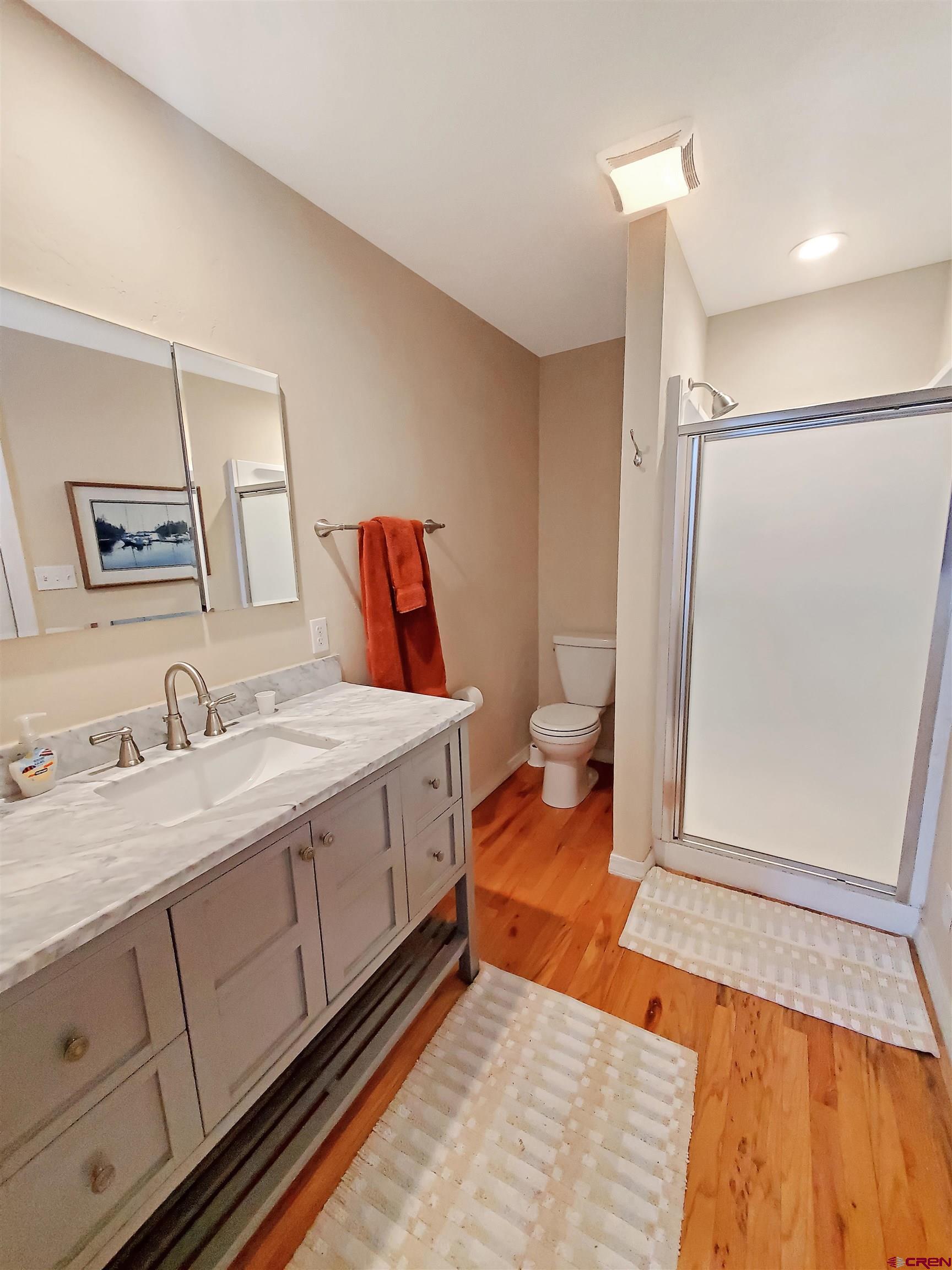 1918 Rolling Road Cortez, CO 81321 - Photo 17 of 26 a spacious bathroom with a granite countertop sink and a mirror