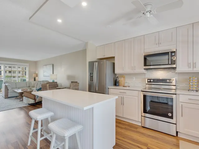 a kitchen with a stove a sink and a refrigerator